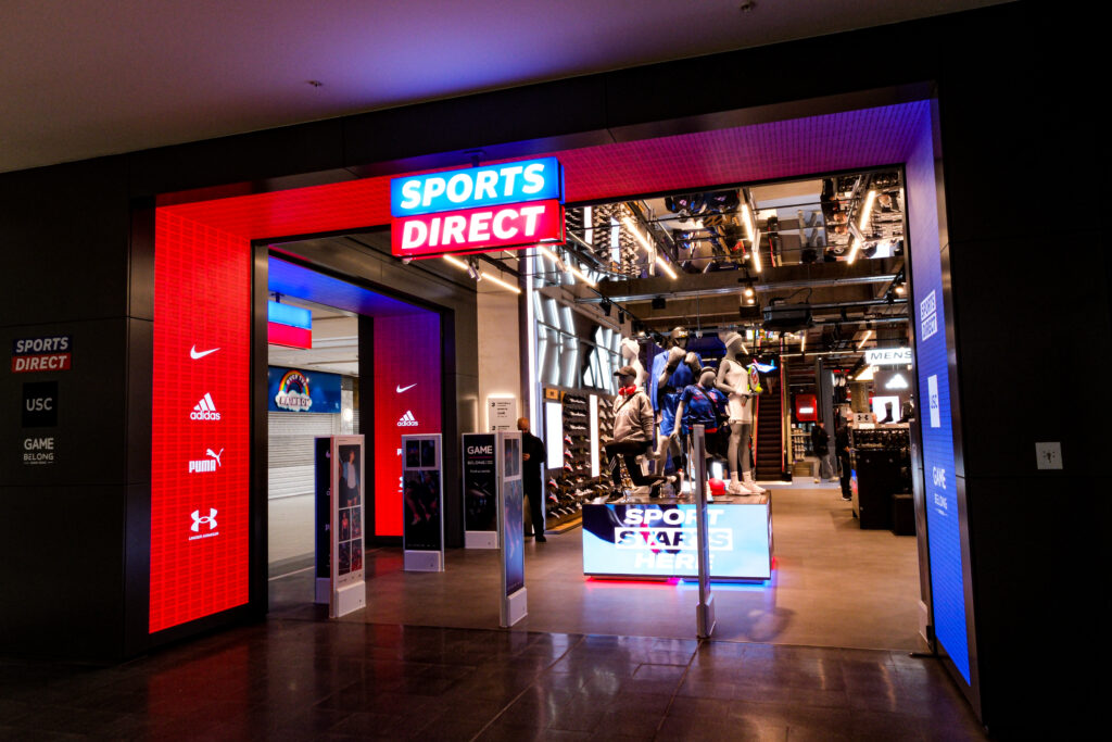 Front of a sports retail store showcasing digital screens