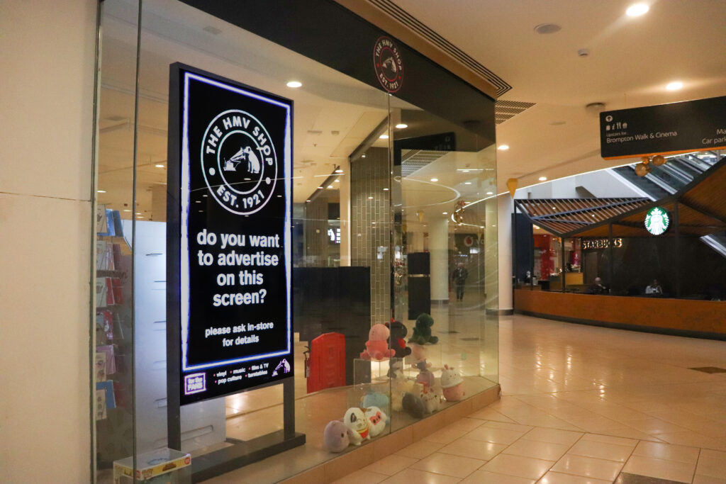 Front of a music retail store showcasing digital screens